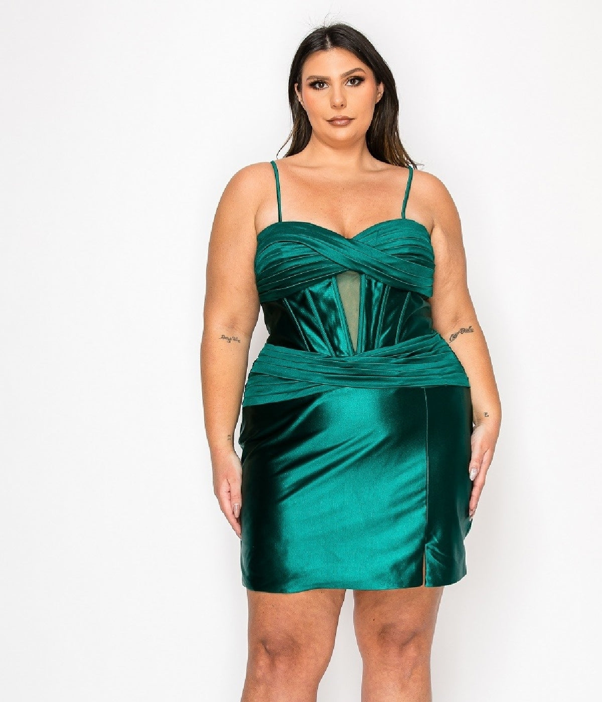 A woman wears the Plus-Size Mini Wedding Guest Dress: Poly USA W1174 in emerald, featuring a sleeveless design with thin straps and a mesh panel, standing against a plain white background.